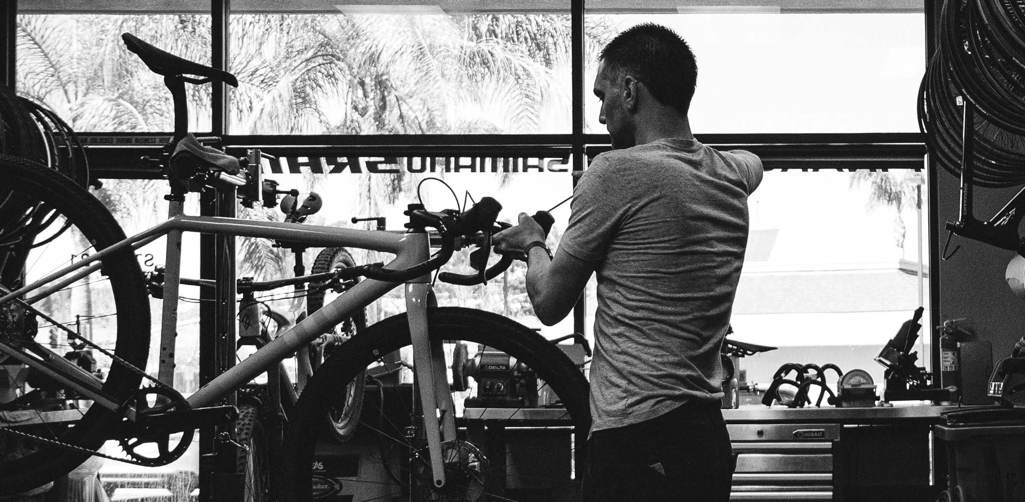 mechanic works on bicycle at stage 21 bike shop